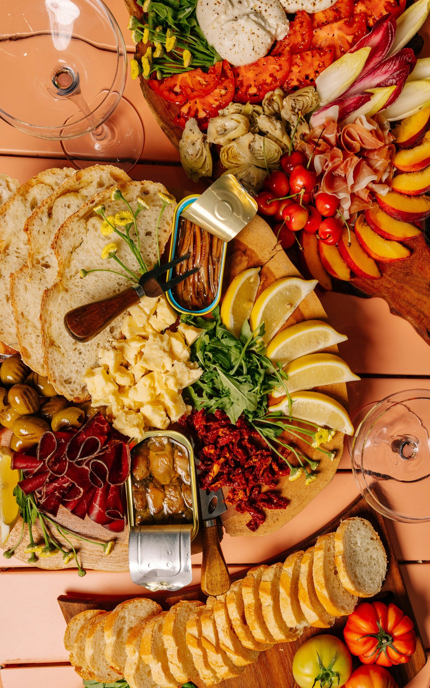 Tasting flight of cheese and cured meats laid out on a white table runner